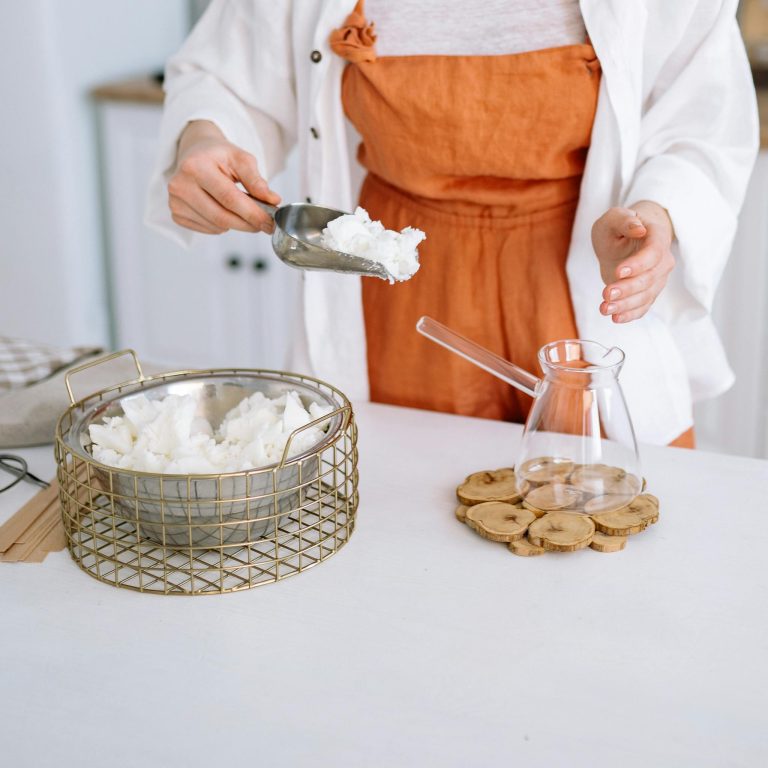 Woman preparing candle wax in a chic setup. DIY handmade candles at home.